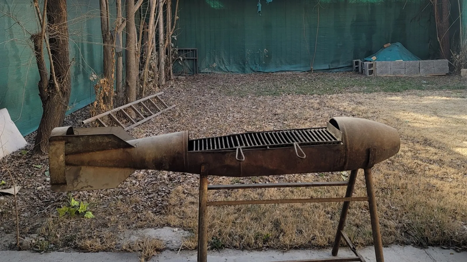 A decommissioned rocket shell mounted on legs and reused as a bench.